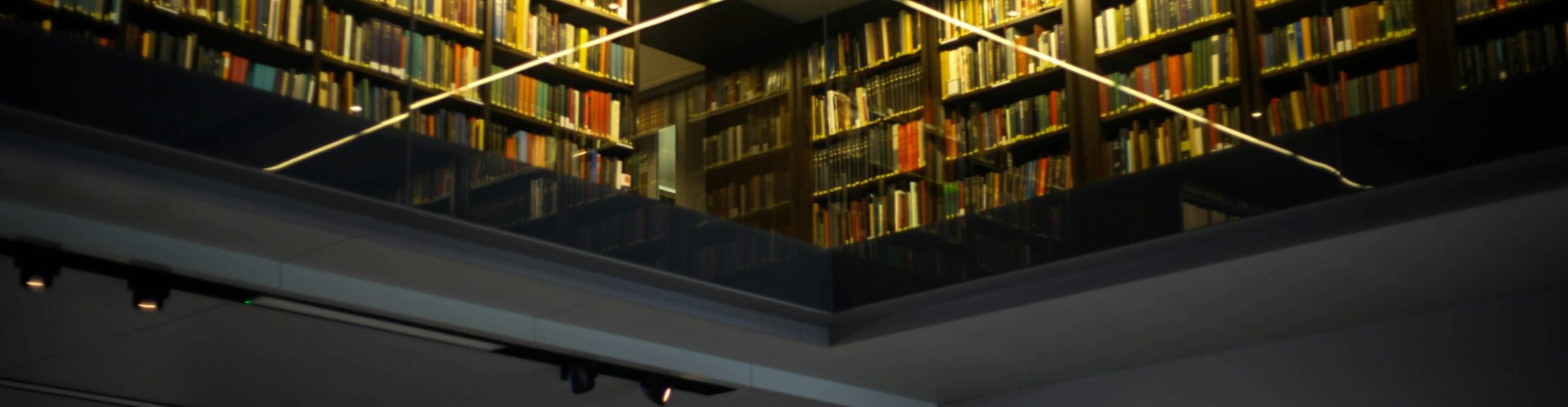 pexels-photo-163662-163662 Interior view of a modern library featuring bookshelves and glass reflections.